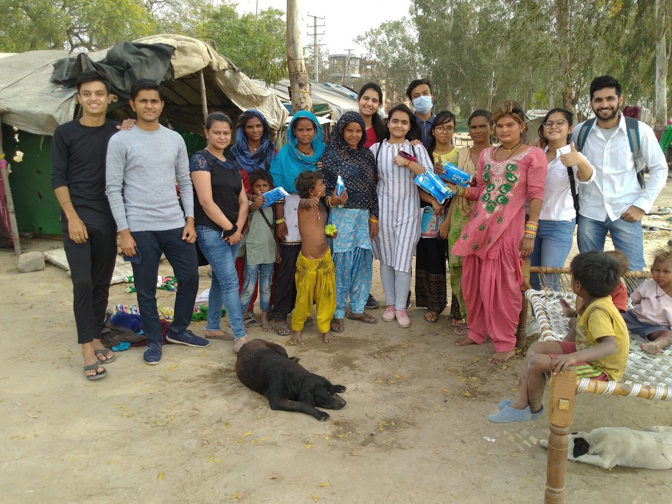 Underprivileged children holding storybooks during an SVSPF book distribution and reading programme